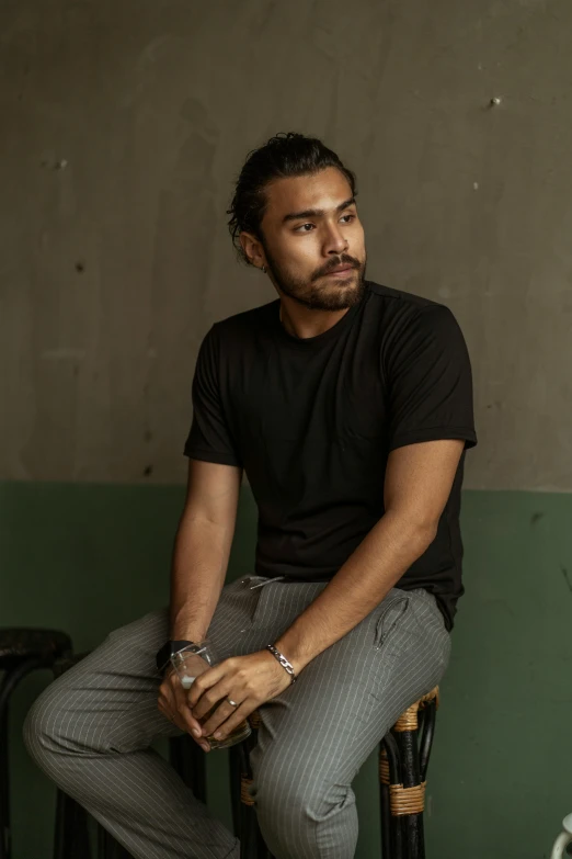 a young man sitting on top of a chair