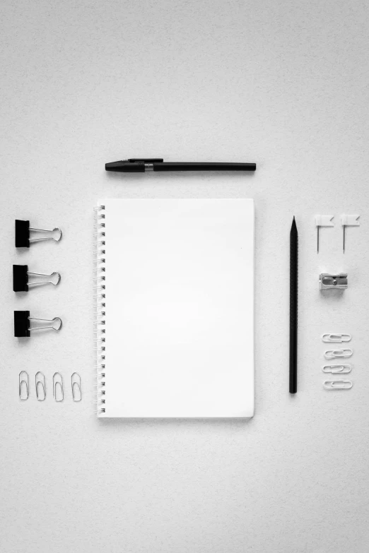 white paper on top of the desk with black pencil