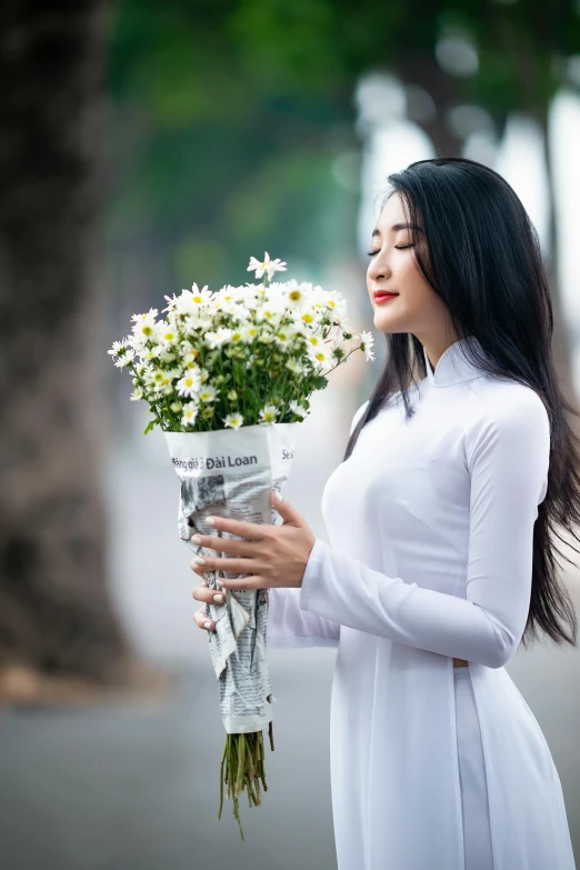 a woman holding a bouquet of flowers