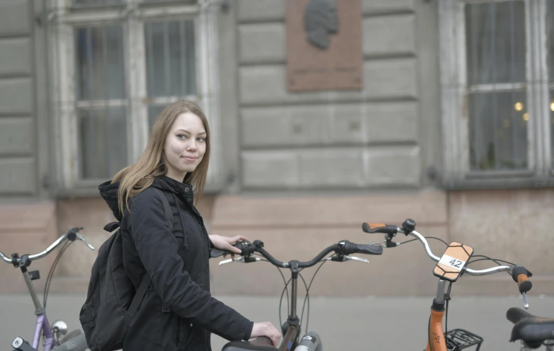 the young woman is posing for a picture with her bike