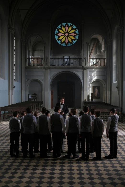 a bunch of men standing in a large room