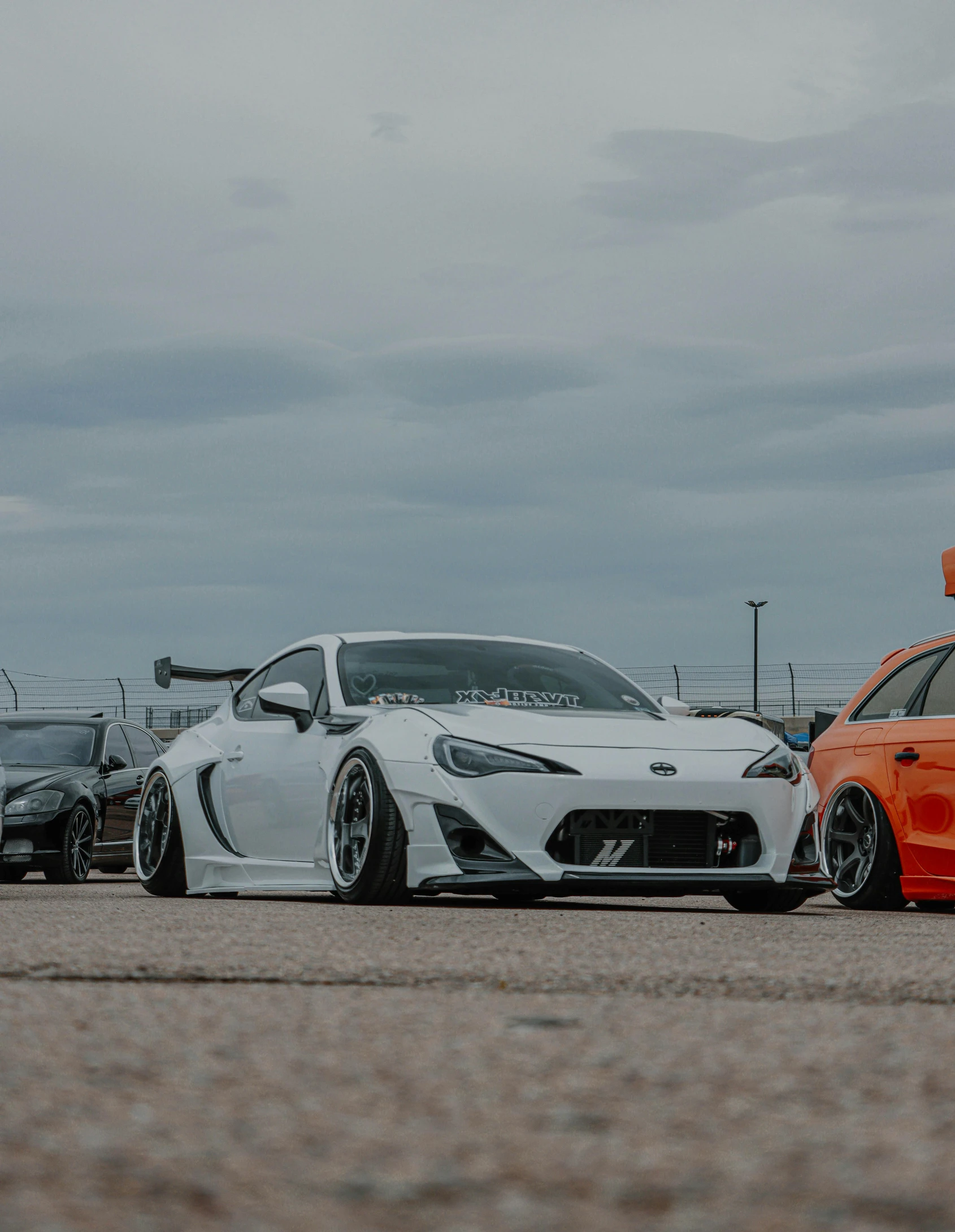 two sport cars parked near each other on the ground