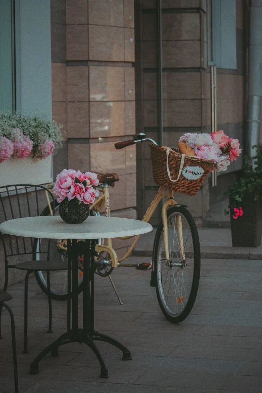 a bicycle sits at an outdoor table and chair