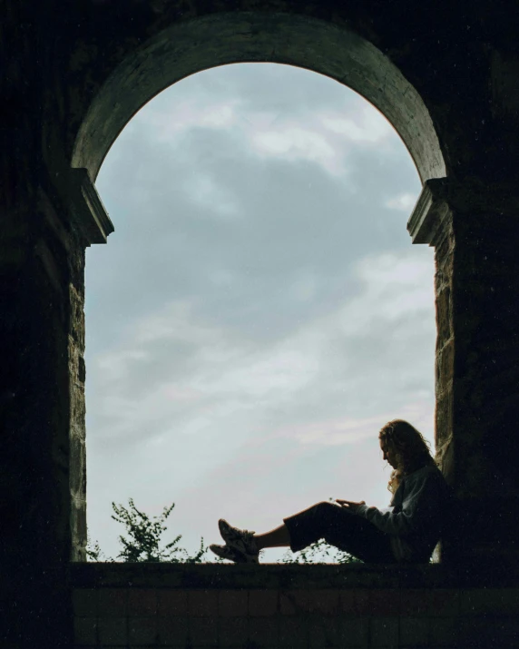 a man sitting down and writing on his laptop