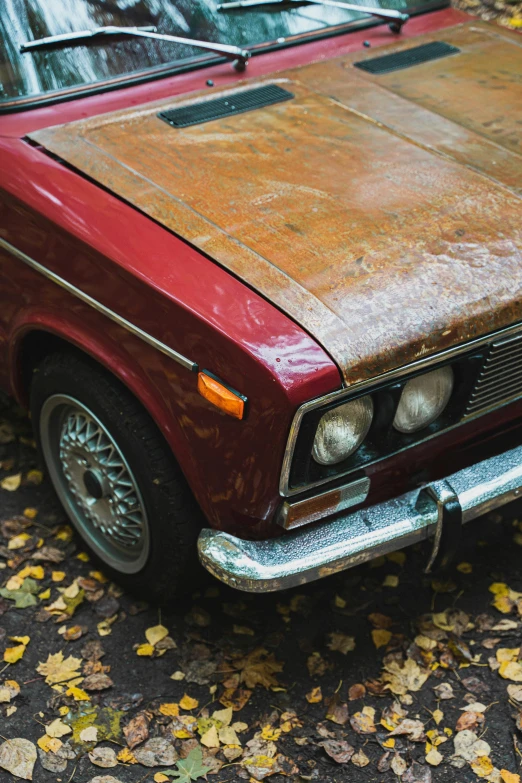 an old rusty looking vehicle sitting on the pavement