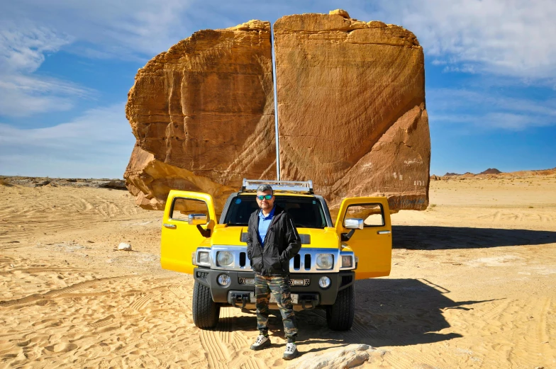 the man is posing for a po in front of his truck