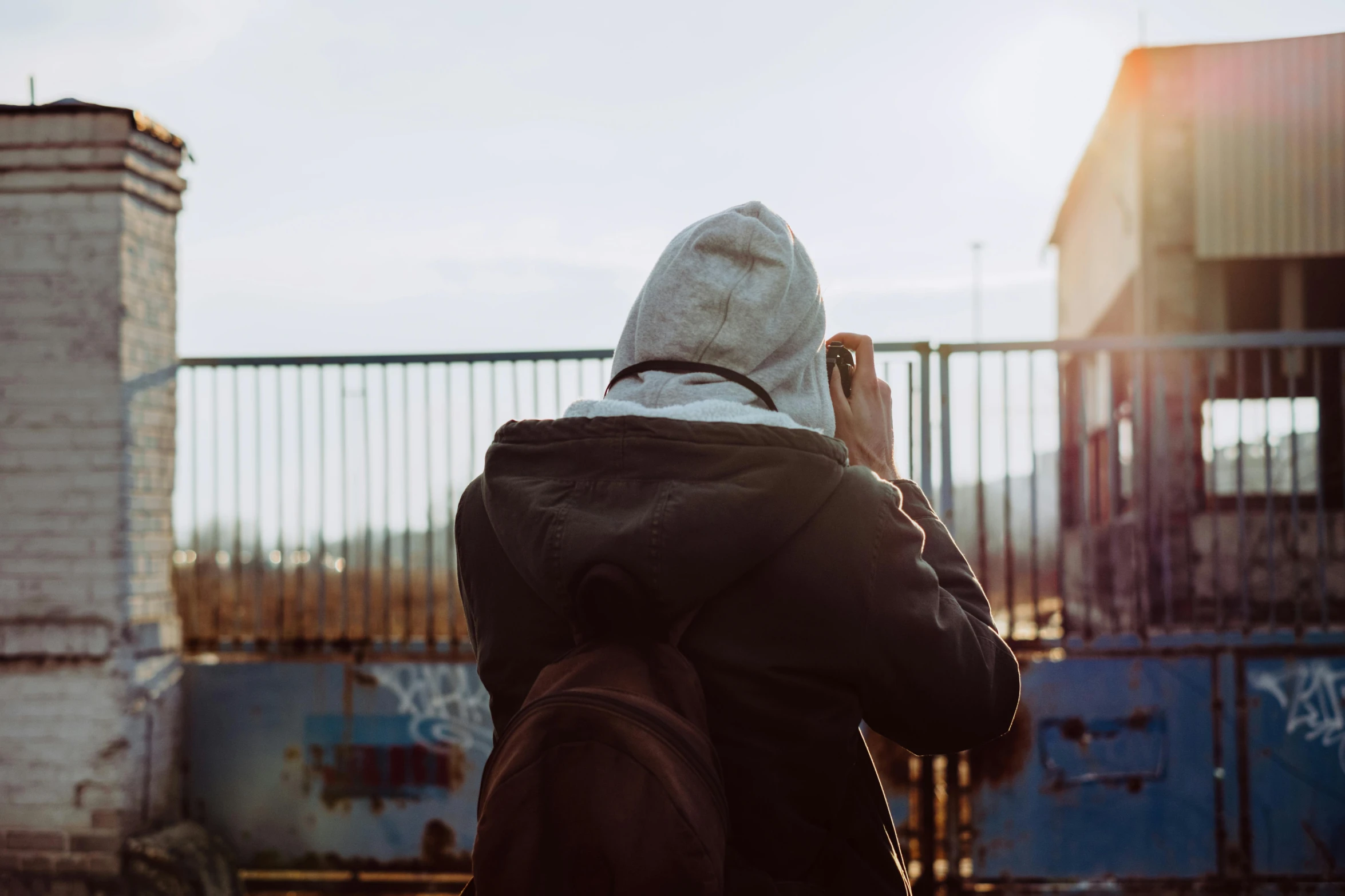 a man on the phone in the street, taking pictures