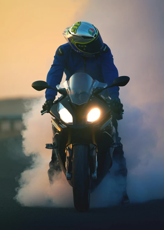 a man rides a motorcycle with smoke and light