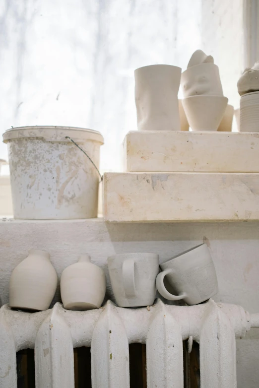 the pots are set on the edge of the shelf