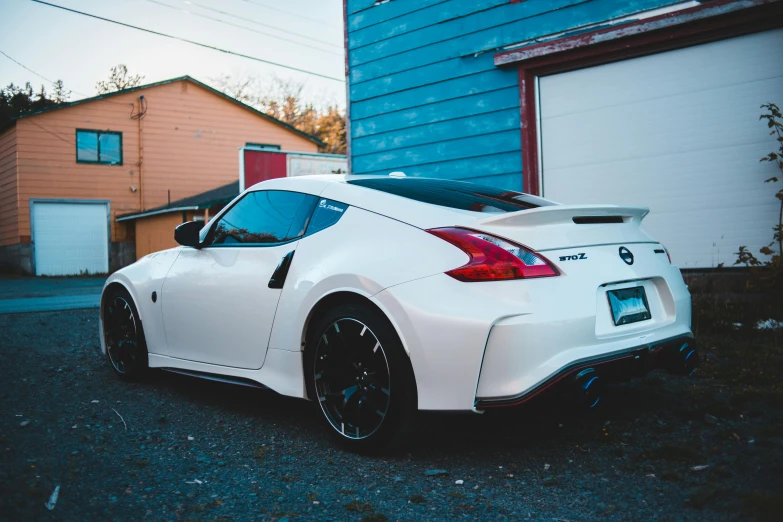 white car parked next to the blue building