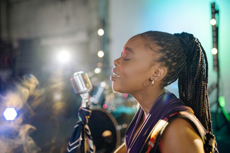 a woman holding a microphone up to her face