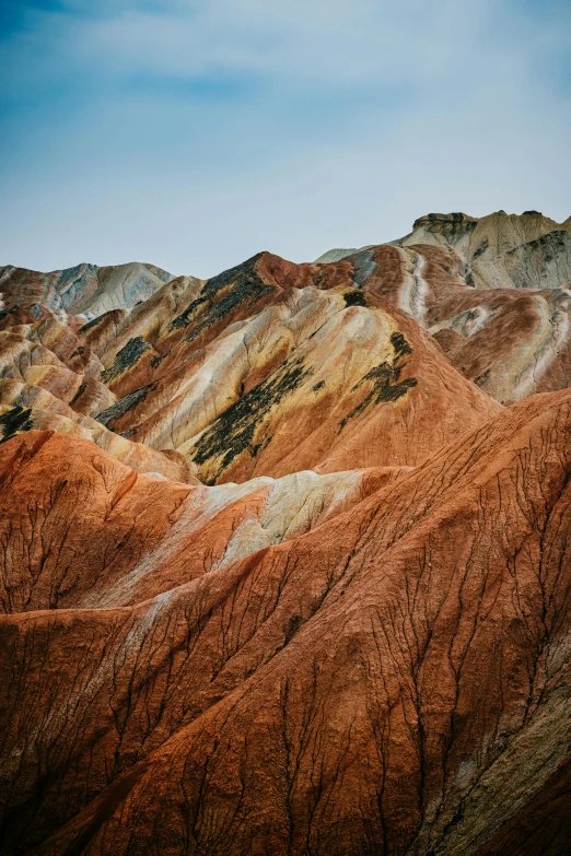 barren mountains with trees on them near an airplane