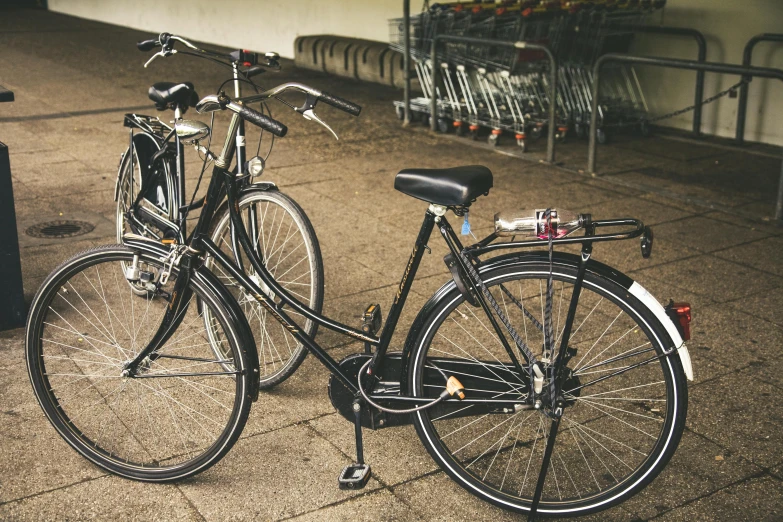 two bikes are parked on the side of a building