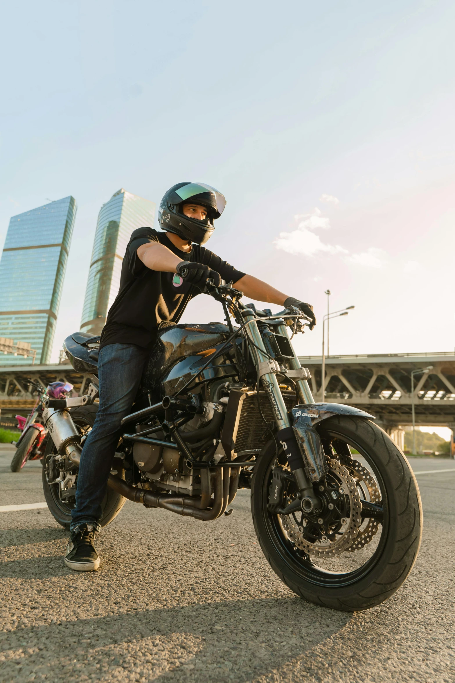 man wearing helmet and sunglasses sitting on motorcycle