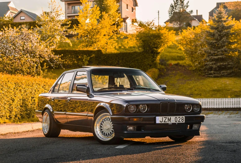 a brown bmw car parked on the street