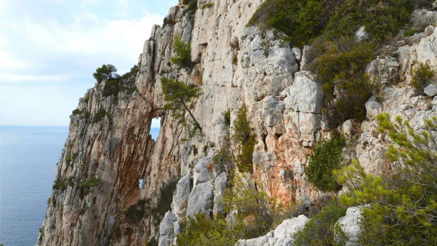 an arch in the rock wall that is partially open