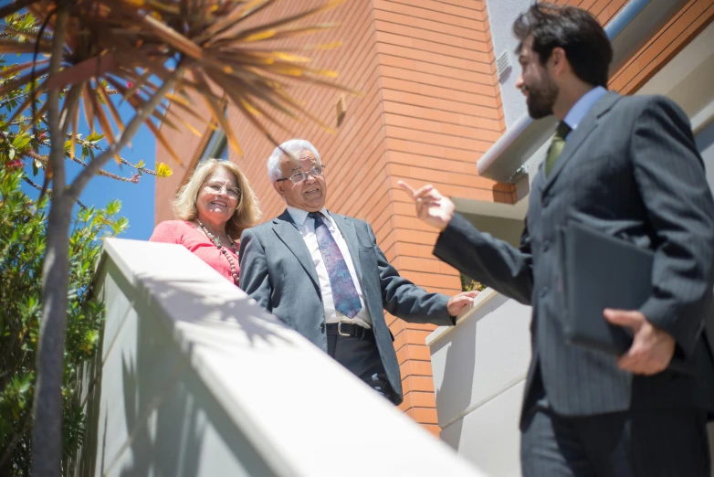 two people in suits are having some discussion outside