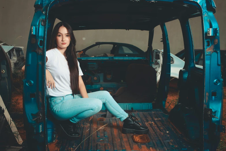 young woman sitting in the back of a truck