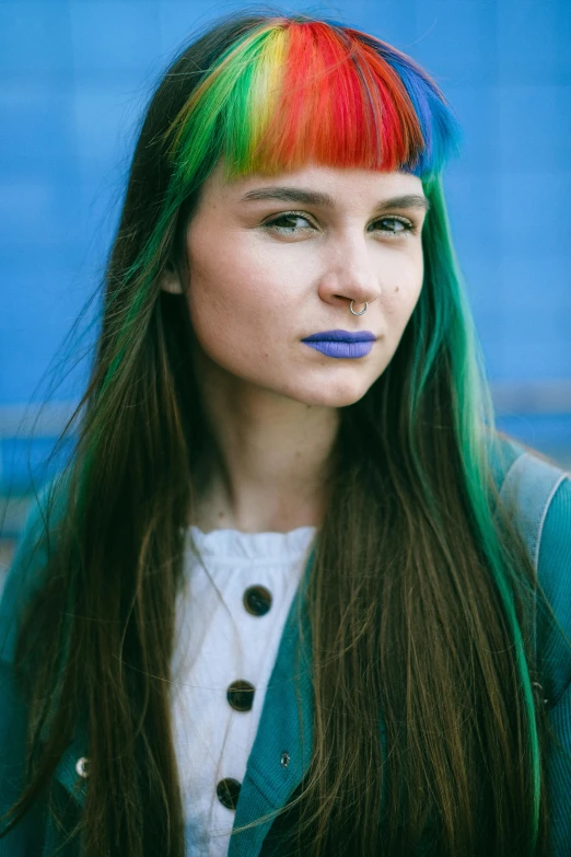 a young woman with colorful hair and rainbow - dyed bangs