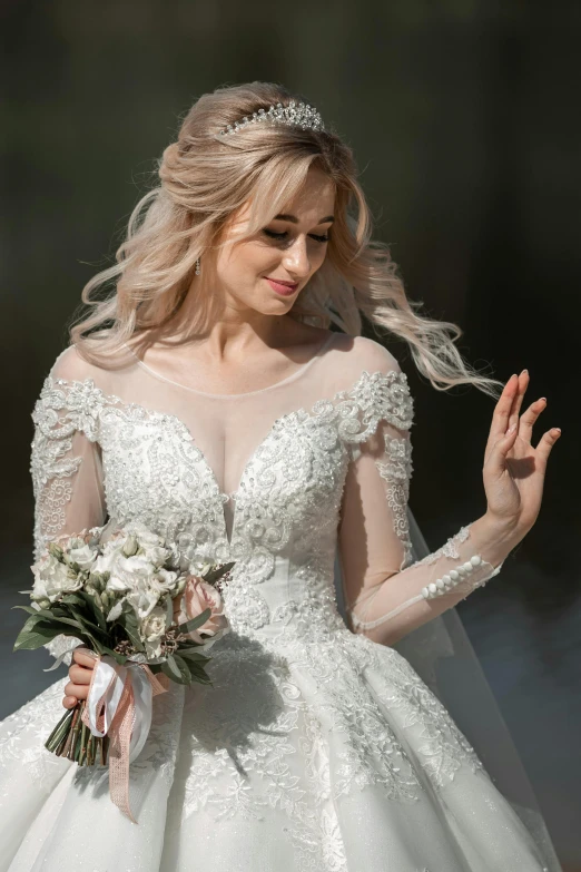 a beautiful bride in her wedding dress with her hands held by her husband