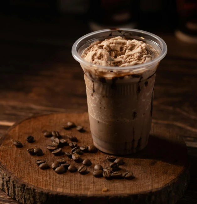 an iced coffee topped with a scoop of coffee and nuts