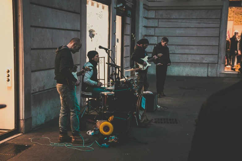 men are standing outside playing with a music instrument