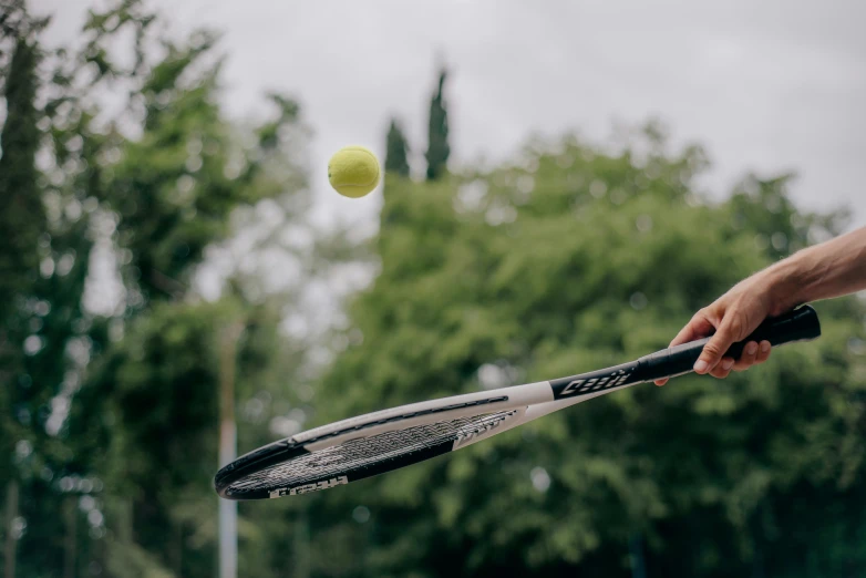 a tennis player about to hit the ball with his racket