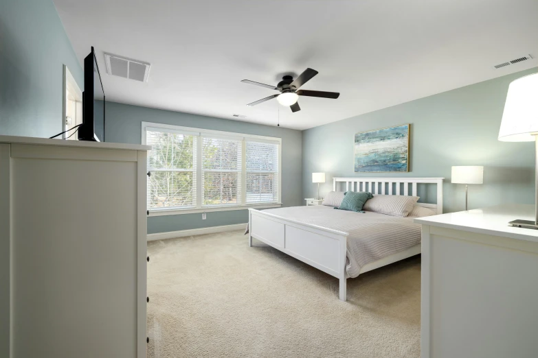 this room features a ceiling fan and a large window