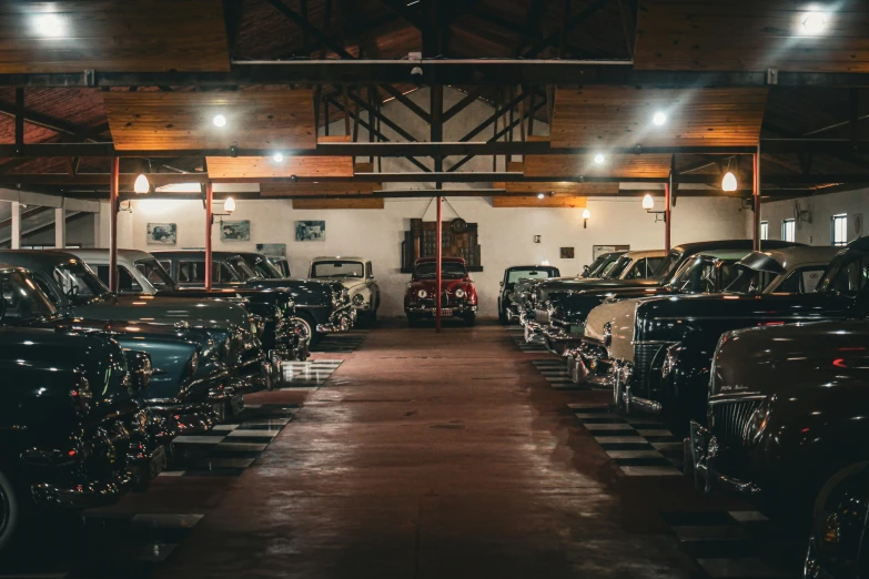 the garage is filled with classic cars waiting to be sold