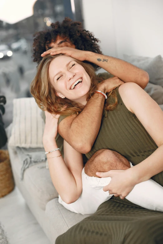 a girl holding another girl over her head with one arm