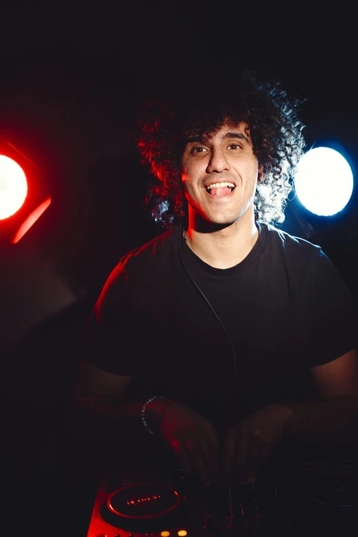 a man smiling with light up red and blue spotlights