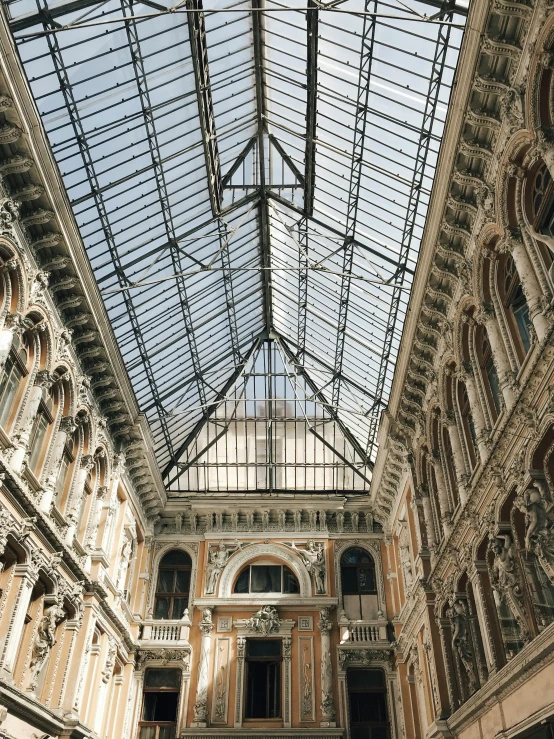 inside the main building of a shopping mall with glass ceiling