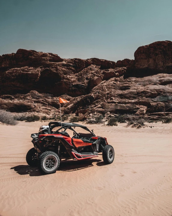 a person is riding an dune buggy on the sand