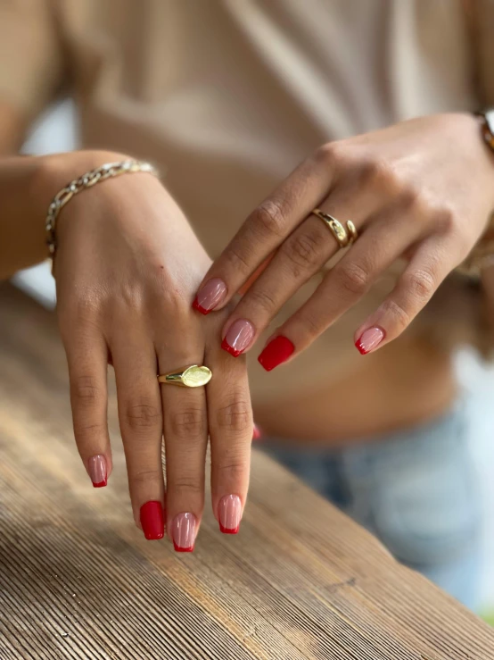 woman sitting at the table and touching a ring