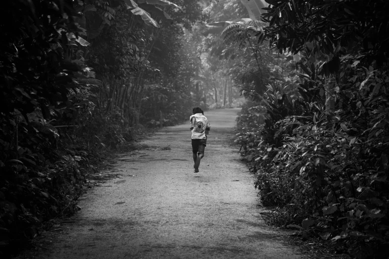 a person with an umbrella walks down a road