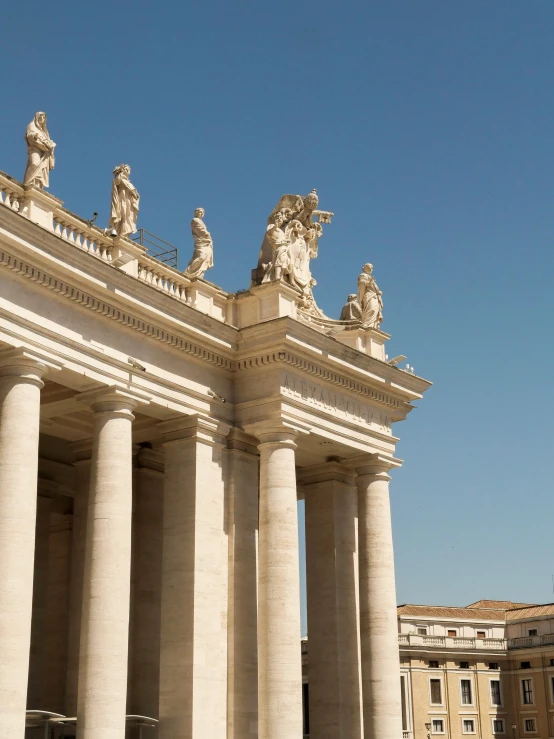 a couple of white pillars with statues at the top of them