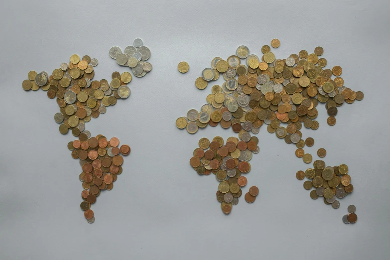 a world map made out of several foreign coins