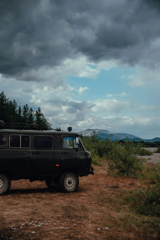 a small van sits in the middle of nowhere