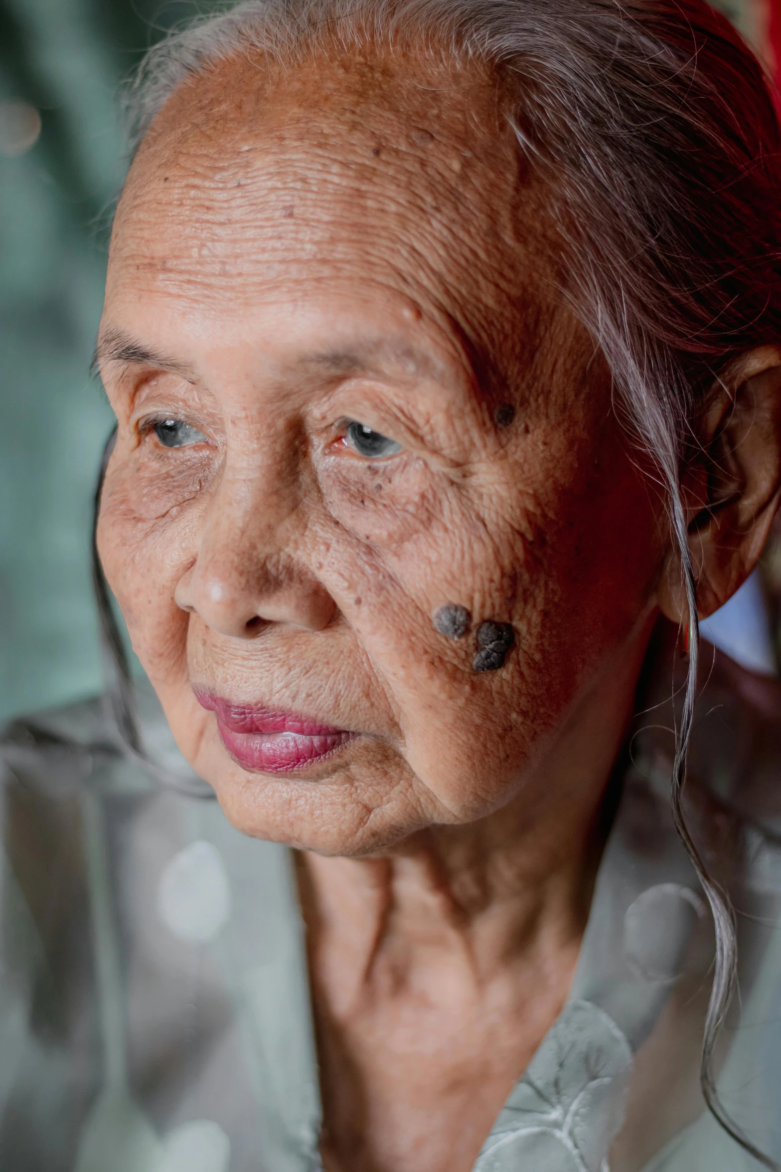 the older woman has tattoos on her face