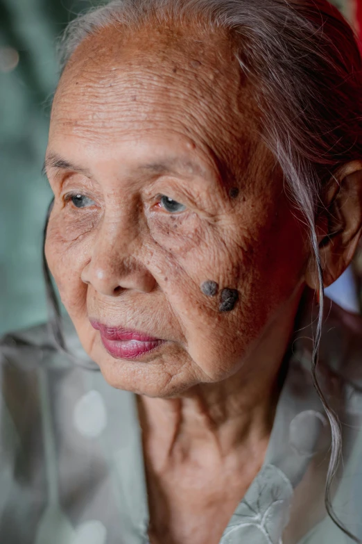 the older woman has tattoos on her face