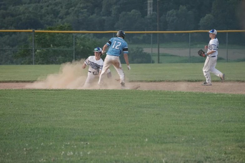 several players in uniforms playing baseball on a field