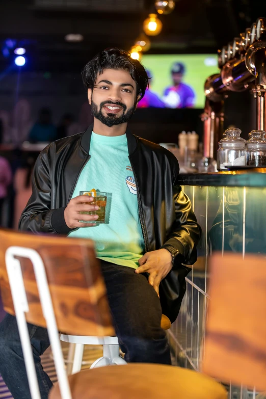 a man sitting at a bar with a cup