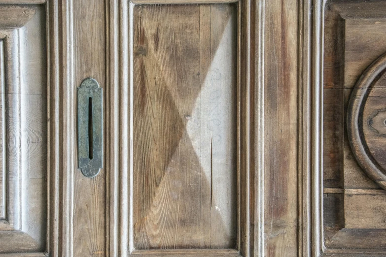 a wooden door with a metal handle