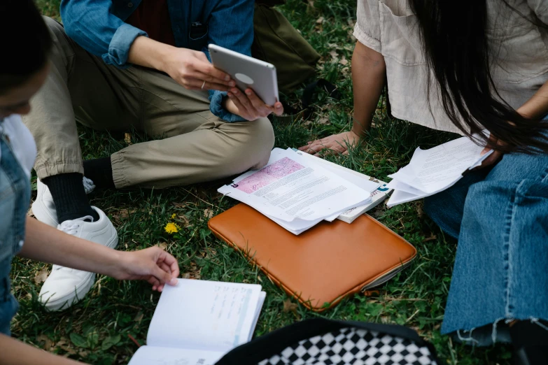 people in a circle working on documents