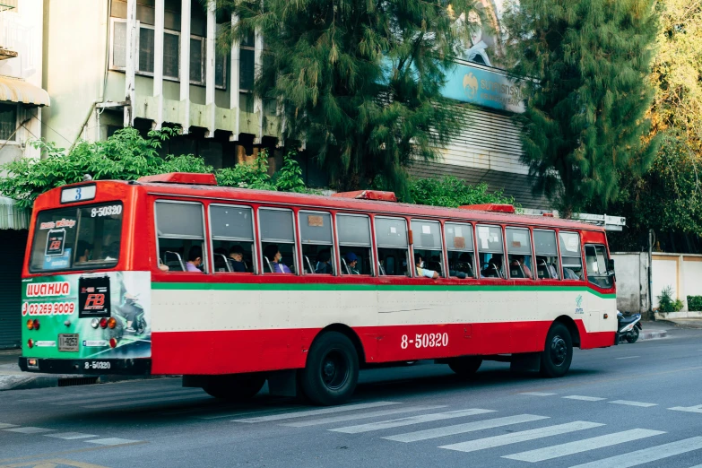 a bus is pulling a trailer down the road