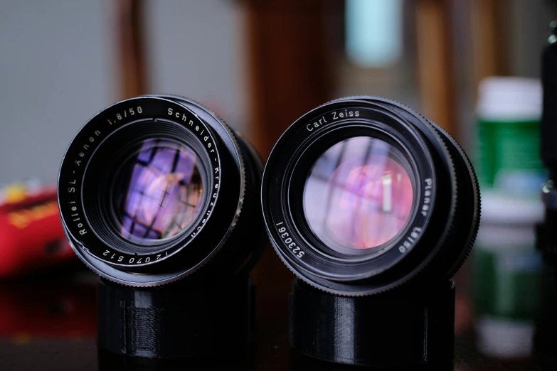 two camera lens with a blurry image on the top