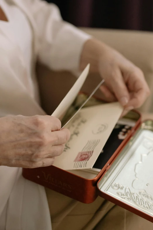 a person is putting the papers inside a briefcase