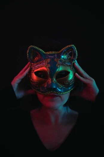 a woman in black shirt covering her face with colorful neon lights