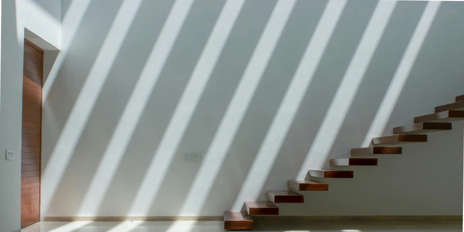 two brown steps against a wall with white striped walls