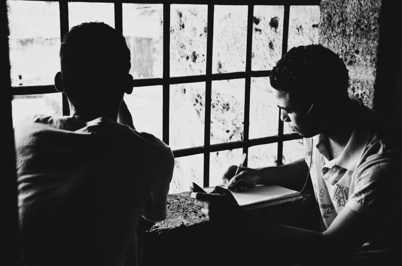 a couple of people sitting in a room with a window